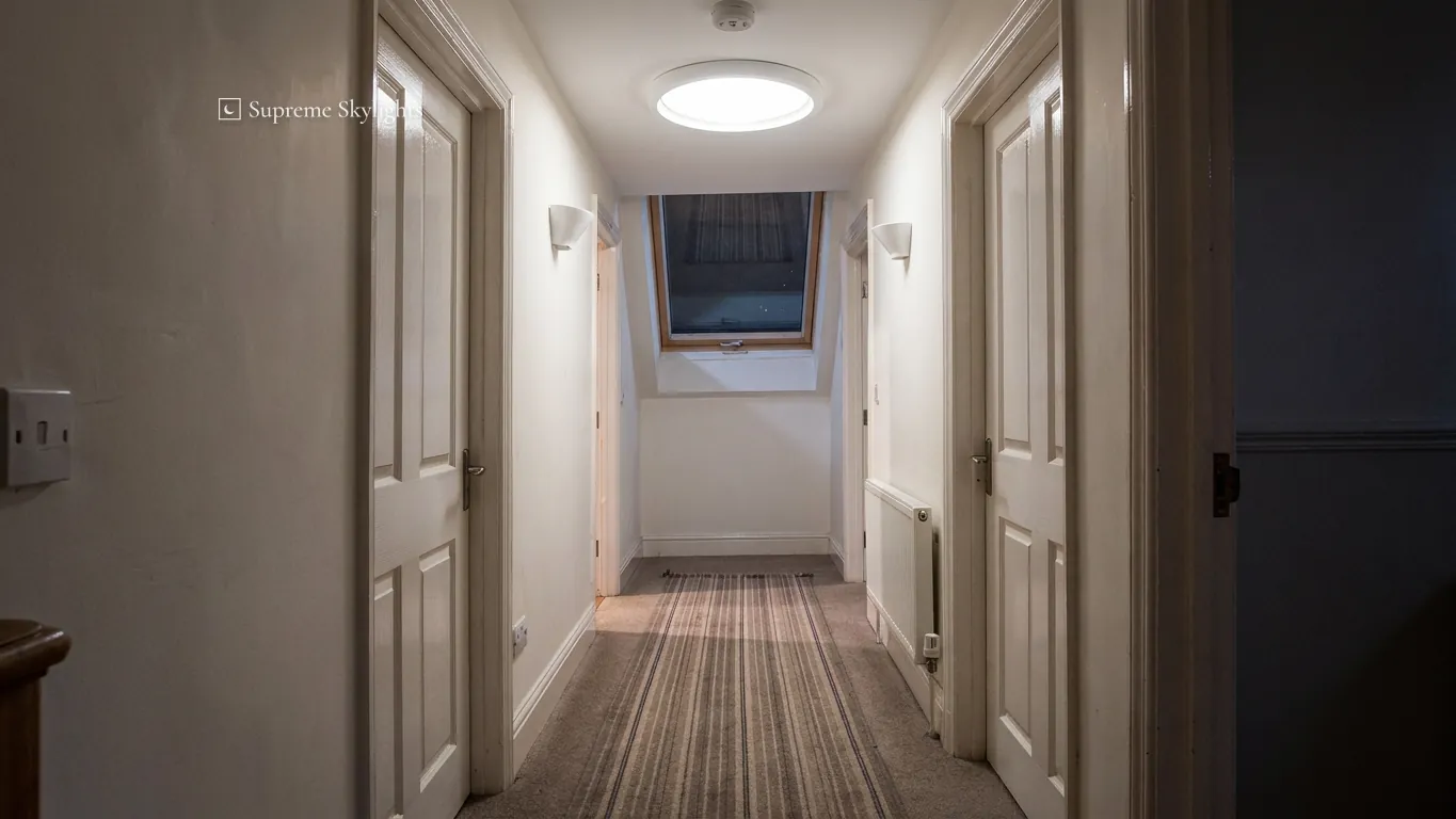 The same landing by day, lit by the round sun tunnel diffuser in the ceiling
